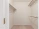 Empty walk-in closet with carpet flooring and white shelving at 17247 N 106Th Ave, Sun City, AZ 85373