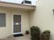 Exterior showcasing a secure front door entry, with decorative shrubbery and a potted plant at 17247 N 106Th Ave, Sun City, AZ 85373