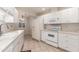 Bright kitchen featuring white appliances, tile flooring, and ample counter space at 17247 N 106Th Ave, Sun City, AZ 85373