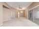 Large living room with carpet flooring, ceiling fan, and sliding doors to patio at 17247 N 106Th Ave, Sun City, AZ 85373