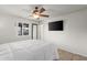 Bright bedroom with wood floors, ceiling fan, a TV, and natural light from the window at 18 N 132Nd St, Chandler, AZ 85225