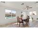 Bright dining area featuring tile floors and natural light streaming through windows overlooking the pool at 18 N 132Nd St, Chandler, AZ 85225