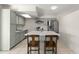 Beautiful kitchen featuring grey cabinetry, a large island with seating, and stainless-steel appliances at 18 N 132Nd St, Chandler, AZ 85225