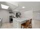 Bright kitchen featuring stainless steel appliances, a skylight, and an island with seating at 18 N 132Nd St, Chandler, AZ 85225