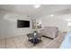 Cozy living room with tile floors, neutral paint, a modern television, and comfortable furniture at 18 N 132Nd St, Chandler, AZ 85225