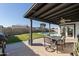 Covered patio with outdoor furniture overlooking a well-manicured backyard and swimming pool at 18 N 132Nd St, Chandler, AZ 85225