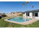 Backyard swimming pool with neat landscaping, green grass, and mature palm trees at 18 N 132Nd St, Chandler, AZ 85225