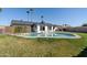 Large in-ground swimming pool with diving board, surrounded by green lawn and mature palm trees at 18 N 132Nd St, Chandler, AZ 85225