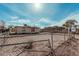 A fenced backyard with a dirt yard and a view of the house at 1813 W Tamarisk St, Phoenix, AZ 85041