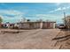 Property exterior view with dirt yard and white single-story building at 1813 W Tamarisk St, Phoenix, AZ 85041