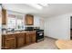 Bright kitchen featuring wooden cabinets, tile floors, and modern appliances at 1813 W Tamarisk St, Phoenix, AZ 85041