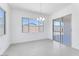 Bright dining area with large windows, modern chandelier, and sliding glass doors at 19094 E Broadmoor Trl, Queen Creek, AZ 85142