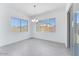 Well-lit dining area with large windows and sliding door to the patio, offering ample natural light at 19094 E Broadmoor Trl, Queen Creek, AZ 85142