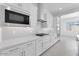 Modern kitchen with stainless steel appliances, white cabinets, and sleek countertops at 19094 E Broadmoor Trl, Queen Creek, AZ 85142