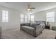 Bright bedroom featuring a pull-out sofa, ceiling fan, and multiple windows offering plenty of natural light at 1915 W Hide Trl, Phoenix, AZ 85085