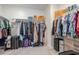 Spacious walk-in closet with ample hanging space, shelving, and storage solutions for organized living at 1915 W Hide Trl, Phoenix, AZ 85085