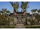 Elegant clubhouse entrance with palm trees, creating a welcoming and luxurious ambiance at 1915 W Hide Trl, Phoenix, AZ 85085