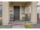 Inviting covered front porch with rocking chairs and a decorative wreath at 1915 W Hide Trl, Phoenix, AZ 85085