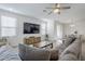 Bright, open living room with modern tile flooring and a ceiling fan at 1915 W Hide Trl, Phoenix, AZ 85085