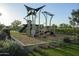 Well-equipped playground with modern structures, surrounded by lush landscaping and turf at 1915 W Hide Trl, Phoenix, AZ 85085