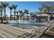 Inviting splash pad area with lounge chairs, palm trees, and shaded cabanas for relaxation and fun at 1915 W Hide Trl, Phoenix, AZ 85085