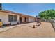 Spacious backyard featuring a covered patio, gravel landscaping, and secure fencing at 20006 N Concho Cir, Sun City, AZ 85373