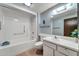 Well-maintained bathroom with a shower-tub combo, vanity sink, and classic tiled floors at 20006 N Concho Cir, Sun City, AZ 85373