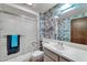 Bathroom featuring a shower-tub combo and large mirror at 20006 N Concho Cir, Sun City, AZ 85373