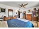 Bright bedroom featuring a ceiling fan, bed, and natural wood furniture at 20006 N Concho Cir, Sun City, AZ 85373