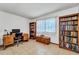 Cozy bedroom with ample natural light, a desk and chair, and built-in bookshelves at 20006 N Concho Cir, Sun City, AZ 85373