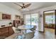 Cozy dining area with a ceiling fan, large window, and easy access to the outdoors at 20006 N Concho Cir, Sun City, AZ 85373