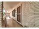 Inviting front porch featuring brick accents, a security door, and ample natural light at 20006 N Concho Cir, Sun City, AZ 85373