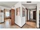 Inviting hallway with decorative art, wood accents, and views into adjoining rooms at 20006 N Concho Cir, Sun City, AZ 85373