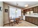 Cozy kitchen area featuring a bright window, dining table, and essential appliances at 20006 N Concho Cir, Sun City, AZ 85373