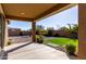 Relax in this outdoor covered patio with gravel landscaping, green lawn, and stone accents at 2019 E Entoro Dr, Casa Grande, AZ 85122