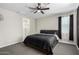 Carpeted bedroom features a ceiling fan and a large window for natural light at 2019 E Entoro Dr, Casa Grande, AZ 85122