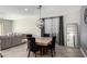 Stylish dining area with a rustic table, velvet chairs, modern chandelier, and designer mirror at 2019 E Entoro Dr, Casa Grande, AZ 85122