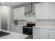 Well-lit kitchen with stainless steel appliances and white cabinets offers modern design at 2019 E Entoro Dr, Casa Grande, AZ 85122