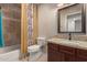 Bathroom with neutral color scheme, a granite vanity and tiled shower with floral curtain at 21 W Ranch Rd, Tempe, AZ 85284