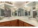 Bathroom features a dual sink vanity, a large mirror, and neutral colors at 21 W Ranch Rd, Tempe, AZ 85284