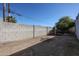 Wide backyard enclosed with block wall, and a mature tree offering shade at 2113 N Squire Ave, Tempe, AZ 85288