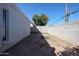 Enclosed backyard with a view of a mature tree, offering privacy at 2113 N Squire Ave, Tempe, AZ 85288