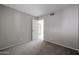 Standard bedroom with plush carpeting, neutral walls, and a view into the hallway at 2113 N Squire Ave, Tempe, AZ 85288