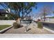 Community sign for Papago Square with mature landscaping and a red car driving nearby at 2113 N Squire Ave, Tempe, AZ 85288