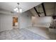 Open-concept living area with tile flooring, a ceiling fan, and an archway leading to the kitchen at 2113 N Squire Ave, Tempe, AZ 85288