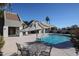 Community pool with umbrella-covered table and chairs for a relaxing poolside atmosphere at 2113 N Squire Ave, Tempe, AZ 85288