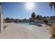 Community pool with clean water, surrounded by lounge chairs and palm trees for a resort-style experience at 2113 N Squire Ave, Tempe, AZ 85288