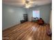 Light-filled bedroom featuring wood-look flooring, ceiling fan and shelving at 21817 W Harding Ave, Wittmann, AZ 85361