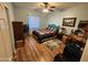 Bright bedroom with wood-look flooring, ceiling fan, and a colorful quilt at 21817 W Harding Ave, Wittmann, AZ 85361