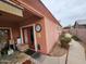 Home exterior featuring covered patio, clock, and desert landscaping at 21817 W Harding Ave, Wittmann, AZ 85361